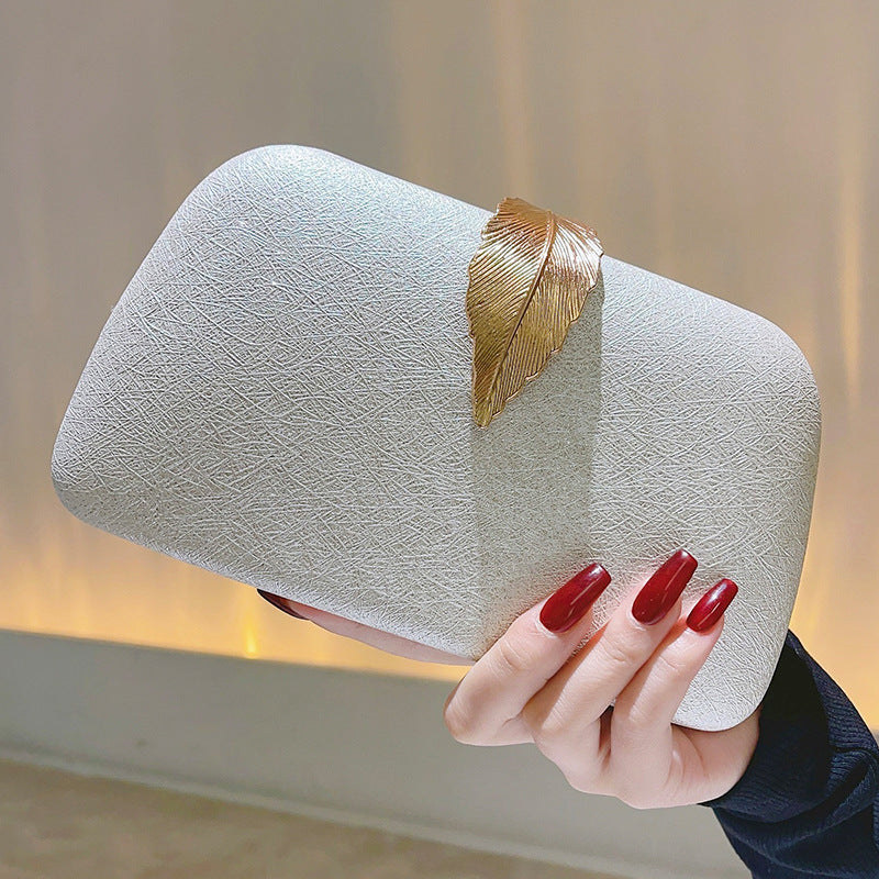 Female Minimalist Dinner Party With Small Square Bag In Hand